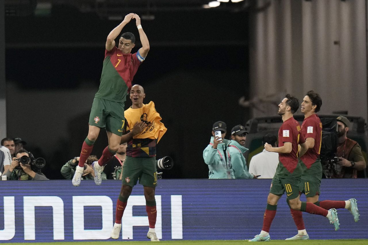 Portugal's Cristiano Ronaldo does his trademark goal celebration Thursday, November 24, after converting a penalty against Ghana to become the <a href=