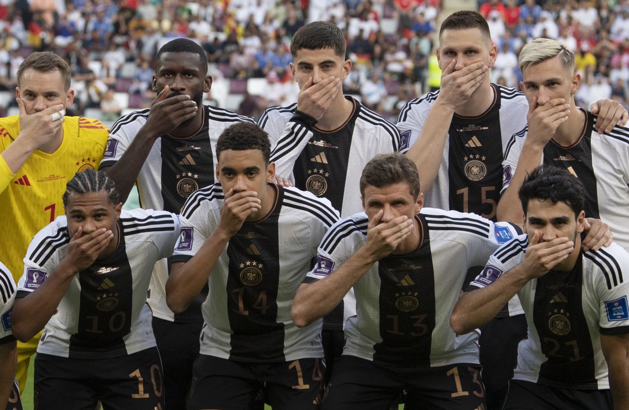 Before their World Cup opener on Wednesday, November 23, Germany's starting 11 posed for their team photo with their right hands in front of their mouths. The team's social media feed confirmed that <a href=