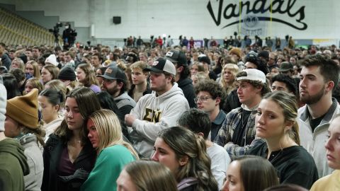 Attendees stand in the Kibbie Dome as family members talk about their loved ones, Wednesday in Moscow, Idaho. 