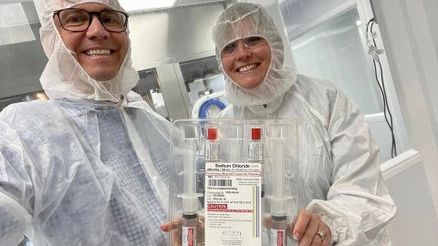 Mark Spiecker, left, and Bray at STAQ in May 2022 to see medications they made come off the line.