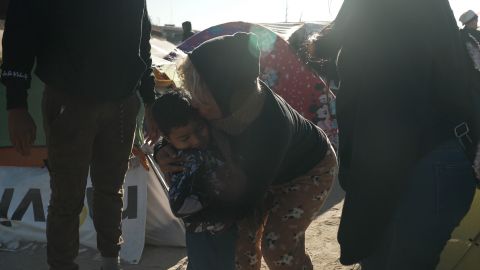 A woman hugs Elias, the son of Venezuelan migrants Franklin Torres and Joribel Gutiérrez, before they cross the Rio Grande into the US on November 17, 2022. 