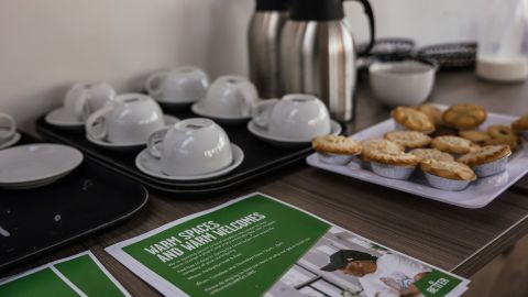Flyers advertising the warm spaces service alongside complimentary refreshments for visitors, at the Ashburton Hall community hub, operated by Greenwich Leisure Ltd., in Croydon, UK, on December 15.