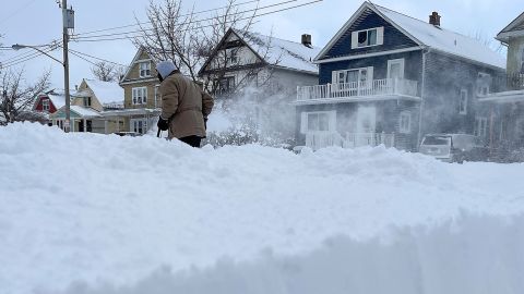 A man clears snow from the front of his home, on Sunday, December 25, 2022, in Buffalo, New York.