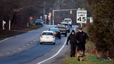 Members of a State Police K-9 unit search on Chief Justice Cushing Highway in Cohasset, Massachusetts, January 7, 2022.