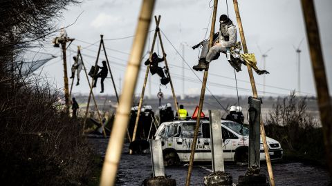 German police work to remove activists from poles in the occupied village of Lützerath.