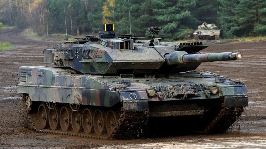 A Leopard 2 A7 main battle tank of the German armed forces Bundeswehr drives through the mud in the context of an informative educational practice 