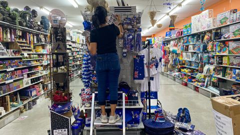 A shop assistant stocks shelves with Australia Day merchandise at a variety store in Brisbane on January 25, 2023.