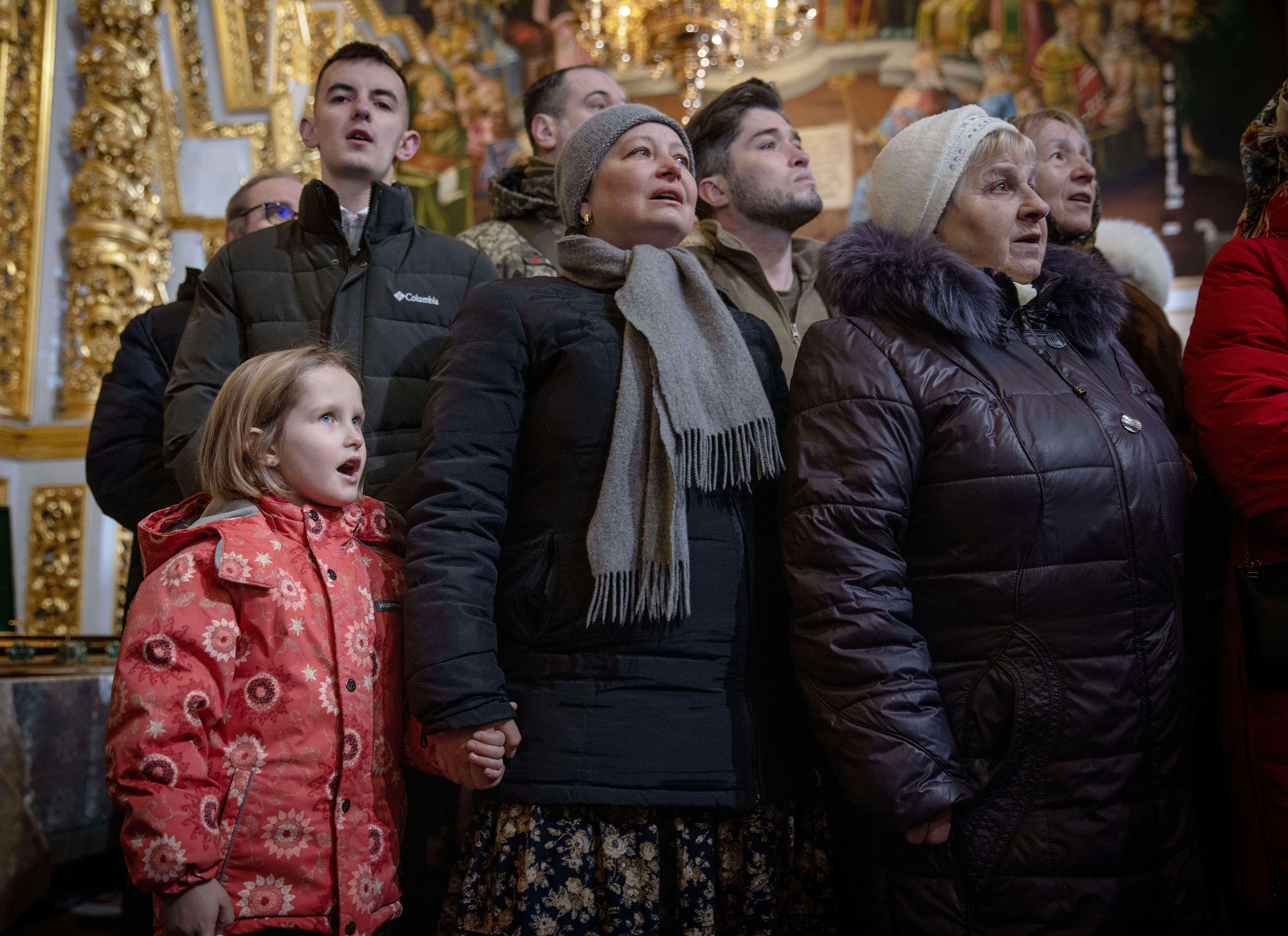 People sing as Metropolitan Epiphanius conducts an Orthodox Christmas service at Kyiv-Pechersk Lavra on Saturday in Kyiv. 