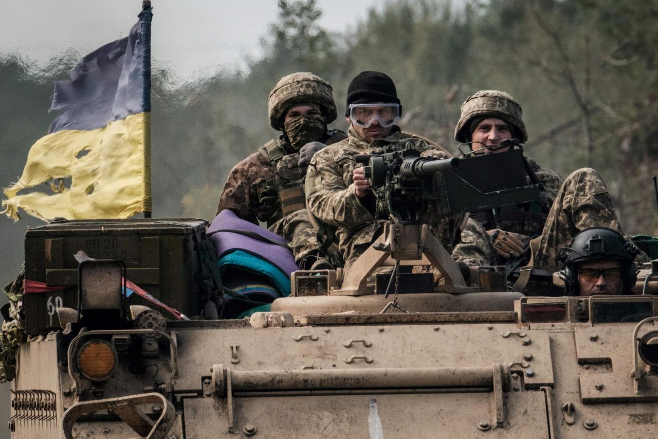 Ukrainian soldiers ride on an armored vehicle near the recently retaken town of Lyman in Donetsk region on October 6, as the <a href=