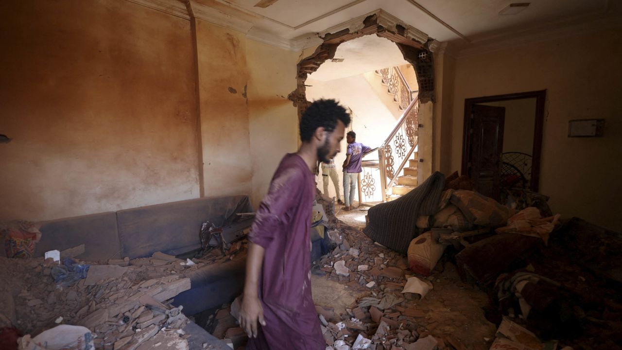 A man inspects a damaged house in Khartoum on April 17.