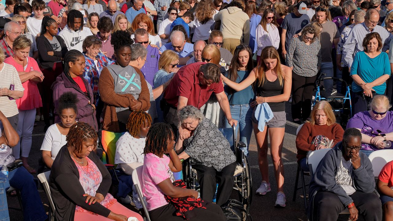 People embrace each other during a vigil in Dadeville on Sunday, the day after the shooting