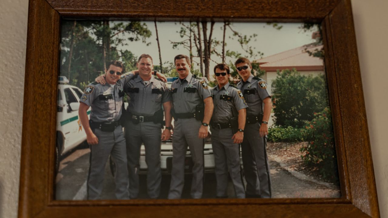 Doug Turner, a former deputy who patrolled with Steven Calkins, has a framed photo of them with other officers. Calkins is in the center. 