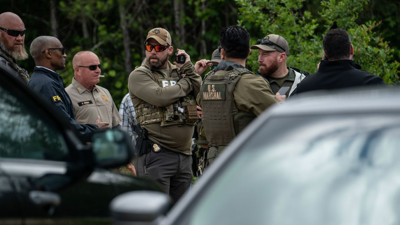 Law enforcement search for the suspect a few miles from the scene where five people, including an 8-year-old child, were killed after a shooting inside a home on April 29, 2023 in Cleveland, Texas.