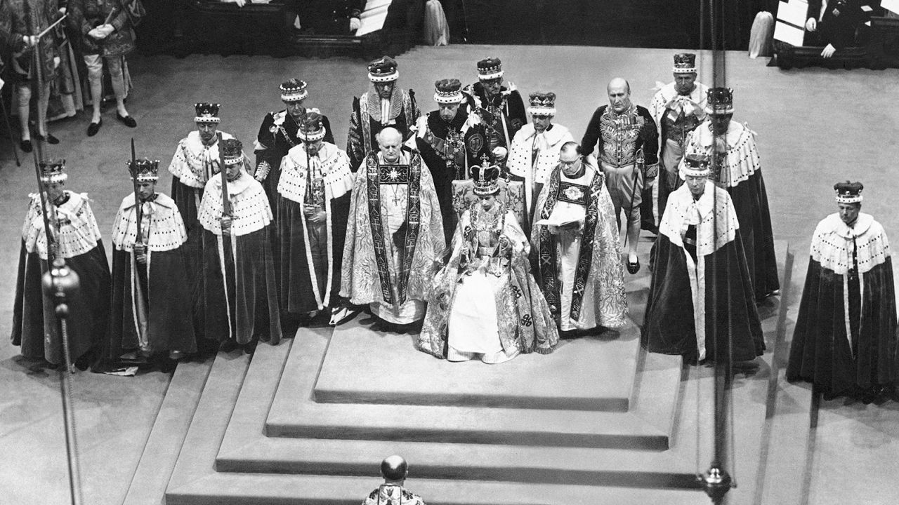 Surrounded by peers and churchmen, the newly crowned Queen Elizabeth II sits on the throne in Westminister Abbey on June 2, 1953.