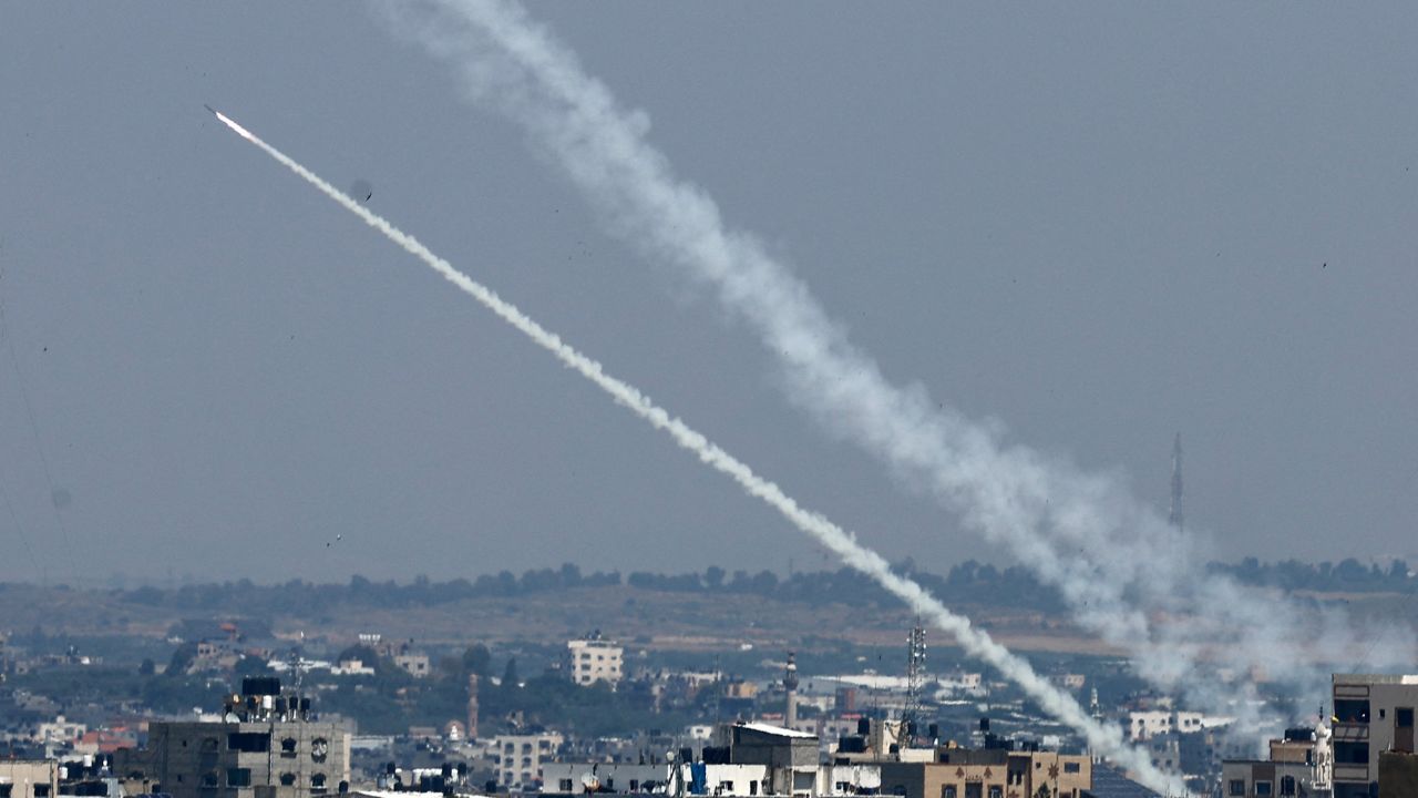 Rockets fired from Gaza into Israel streak across the sky on Wednesday.