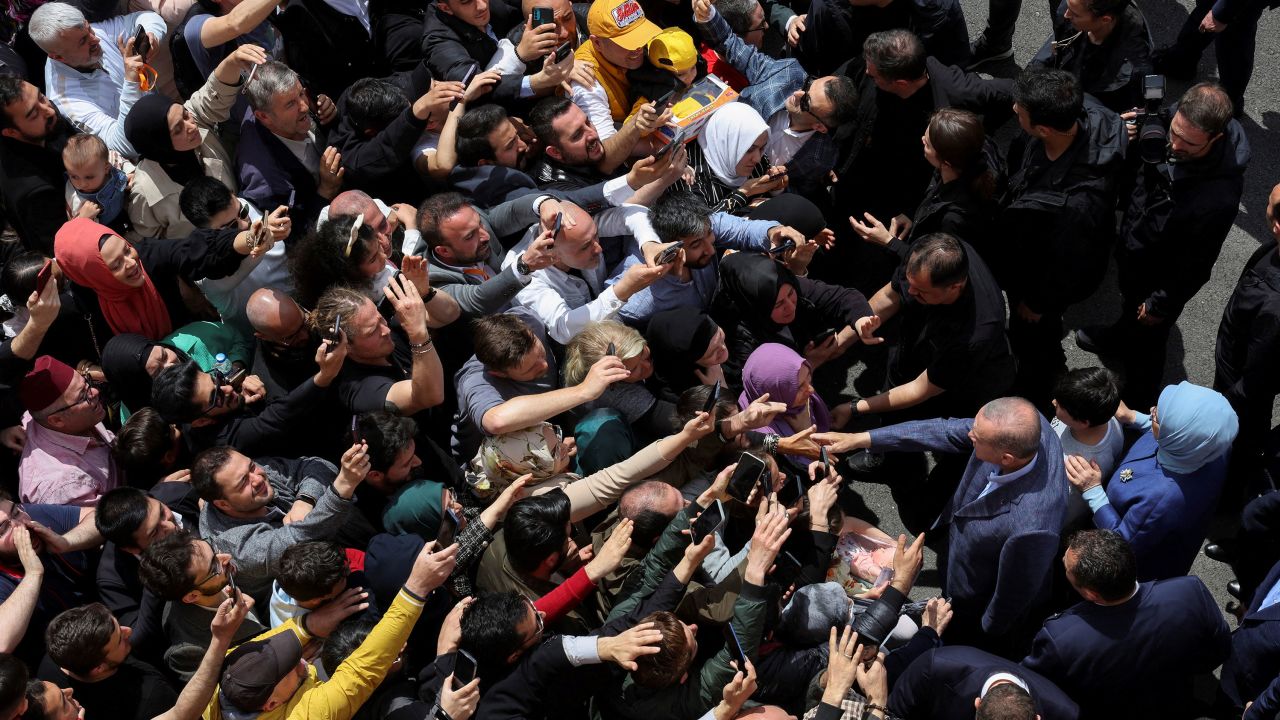 Turkish President Tayyip Erdogan and his wife Emine Erdogan meet supporters outside a polling station in Istanbul, Turkey May 14, 2023.