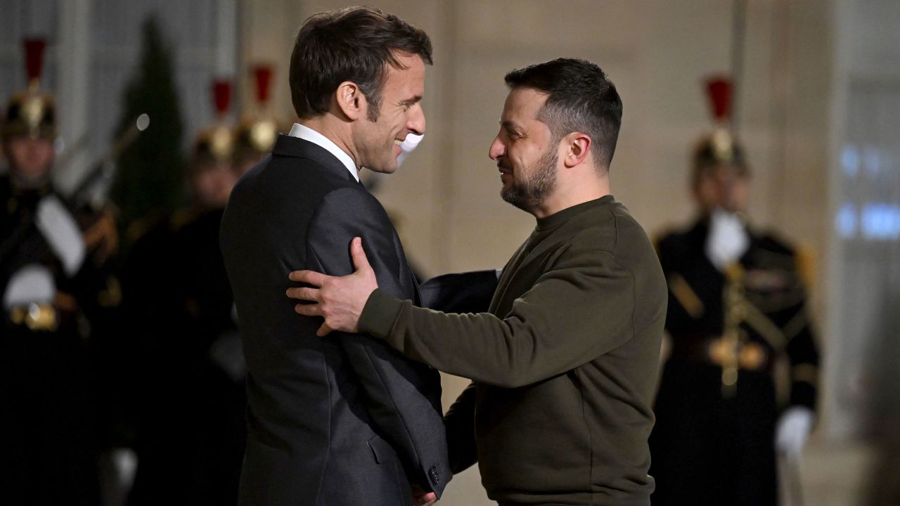 France's President Emmanuel Macron (left) welcomes President Volodymyr Zelensky to the Elysee presidential palace, for a meeting in Paris with Macron and the German Chancellor on February 8, 2023. 