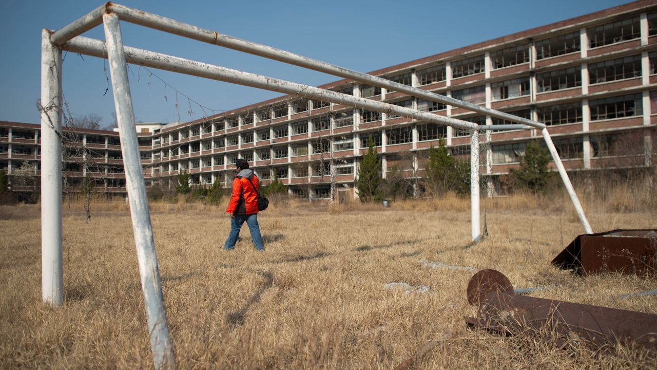 A photographer outside an abandoned school near Daejeon, South Korea, on March 22, 2014.