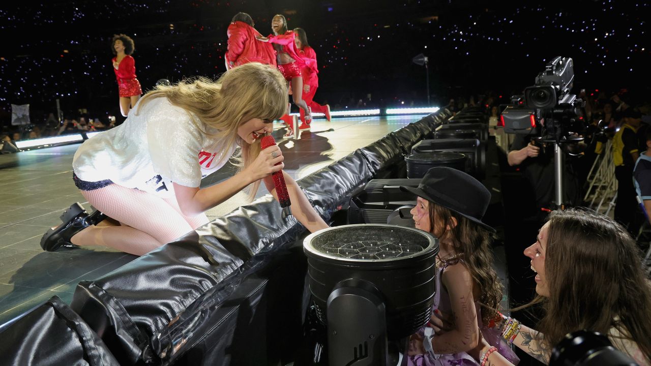 Taylor Swift gives her hat to a young fan during a New Jersey 