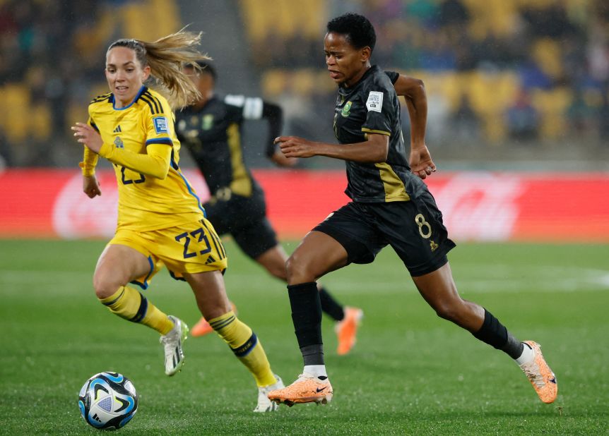 South Africa's Hildah Magaia, who scored the opening goal, runs with the ball alongside Sweden's Elin Rubensson.