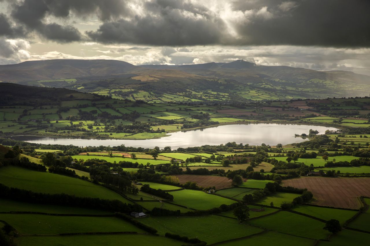 A view over the picturesque Llangorse Lake from Cockit Hill in the Brecon Beacons.