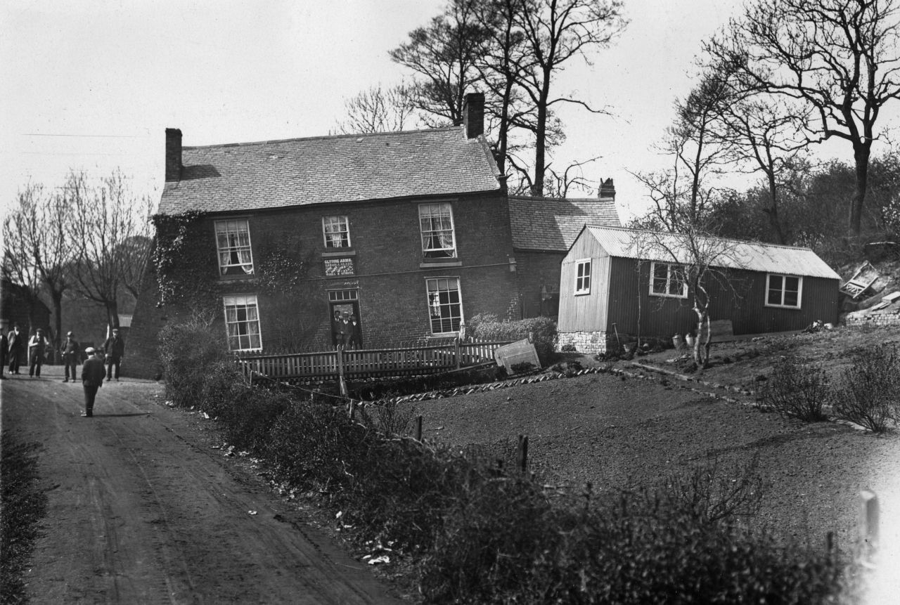 Formely known as The Glynne Arms, a crooked public house and outbuildings, leaning because of subsidence and soil erosion on 17th April 1907.