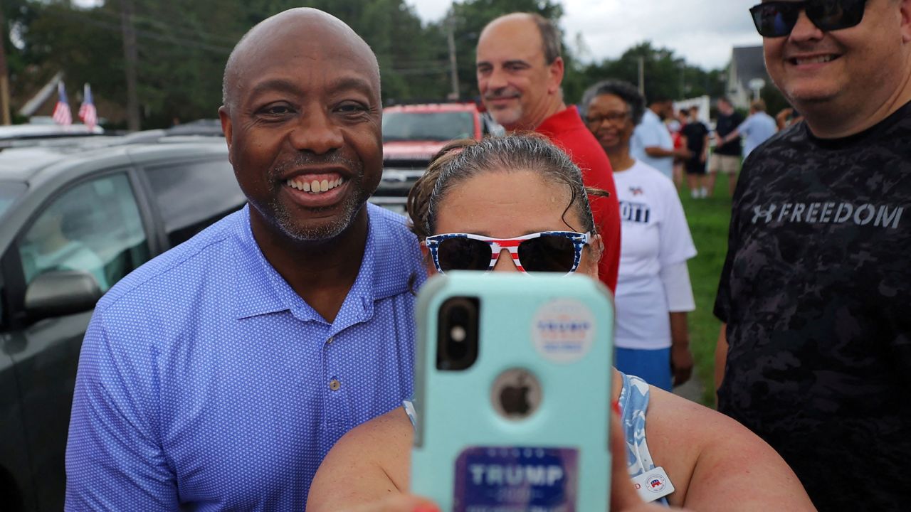 Republican presidential candidate Sen. Tim Scott poses for a selfie at the start of the the Fourth of July Parade in Merrimack, New Hampshire, on July 4. 