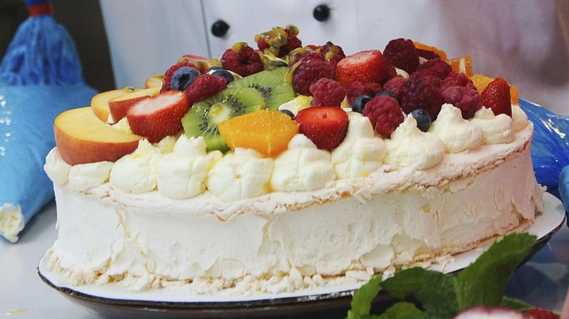 A pavlova cake is typically served with summer fruits heaped on top.