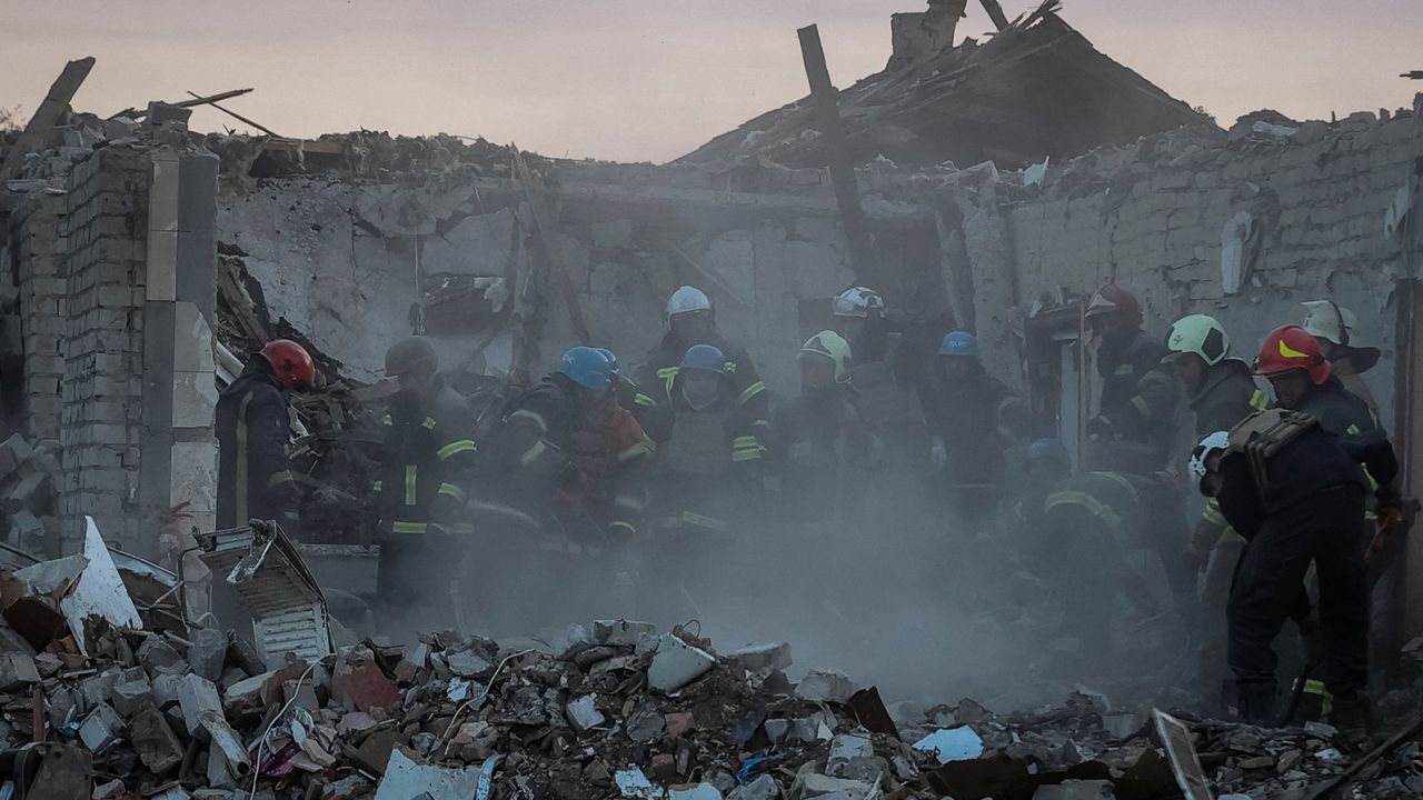 Rescuers work at the site of a Russian military strike in Hroza village on October 5.