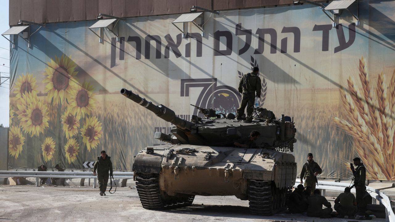 Israeli soldiers gather on and around a tank near Israel's border with the Gaza Strip, in southern Israel on October 15.