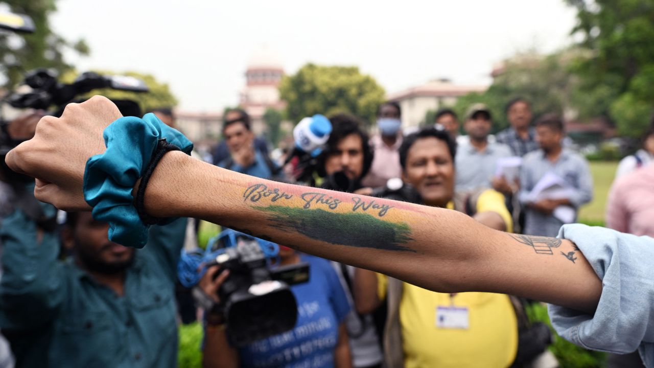 An activist displays a tattoo reading 