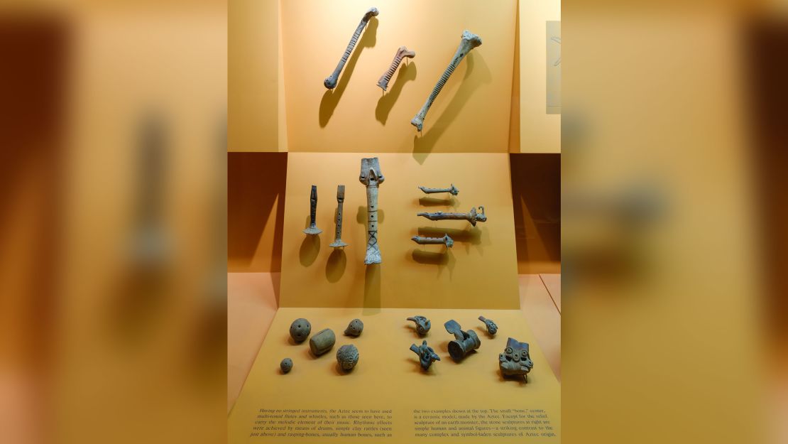 In an exhibit on Aztec musical instruments in the Hall of Mexico and South America, a display of three rasps (percussion instruments) includes a ceramic model (center top) in addition to two made from human bones (left and right, top).