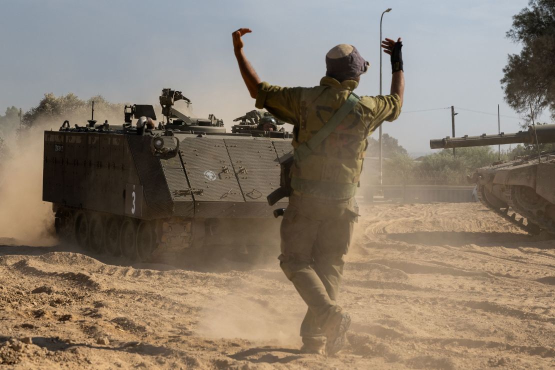 An IDF soldier guides an armored personnel carrier in southern Israel on October 21, 2023.