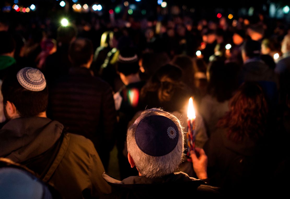 Members and supporters of the Jewish community come together for a candlelight vigil in remembrance of those who died during a shooting at the Tree of Life Synagogue in Pittsburgh.