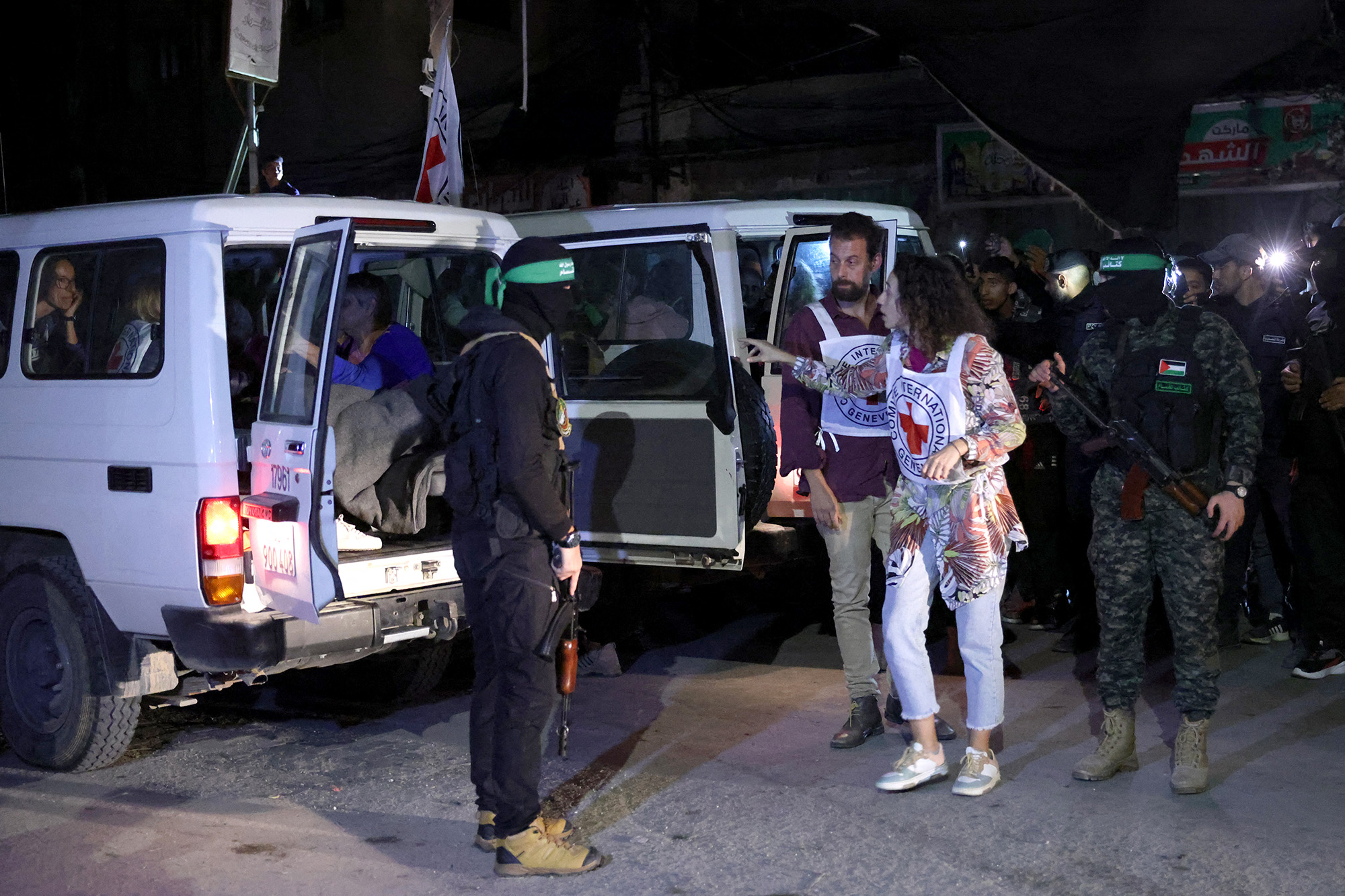 Members of the Red Cross prepare to transport hostages released by Hamas in Rafah, southern Gaza, on November 28, 2023.
