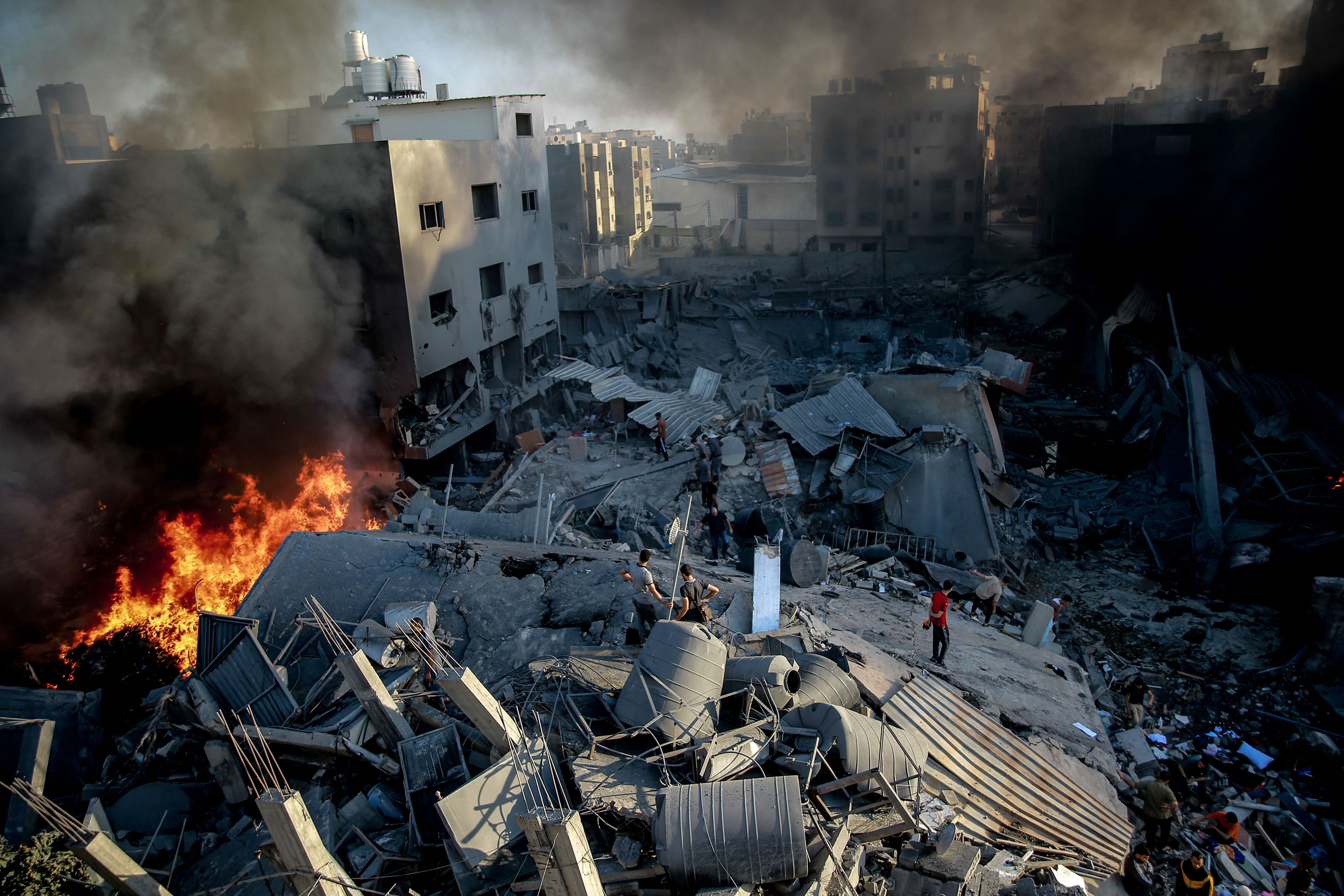 Smoke and fire rise from a leveled building after an Israeli strike on Gaza, on October 26, 2023.
