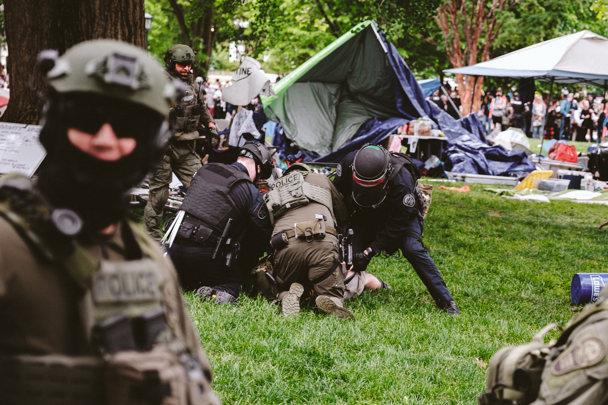 Heavily armed police officers arrest a protester on the grounds of the University of Virginia in Charlottesville, Virginia, on Saturday.